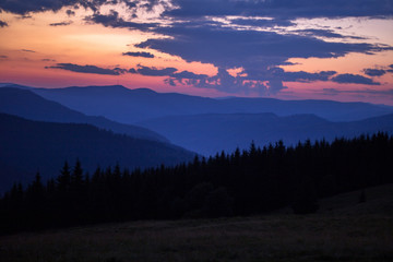 Obraz premium red-blue sunset haze in the mountain gorge, orange-blue sunset in the mountains