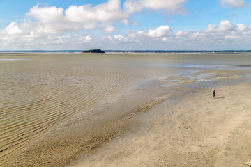 Aerial view of the ocean at low tide from Mont Saint Michel monastery. Textured abstract background. Normandy, France.