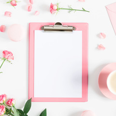 Flowers composition romantic. Flowers roses and rose petals,  clipboard, macaroon, cup coffee on white background. Happy women's day. Valentine's Day.  Flat lay, top view, copy space, square