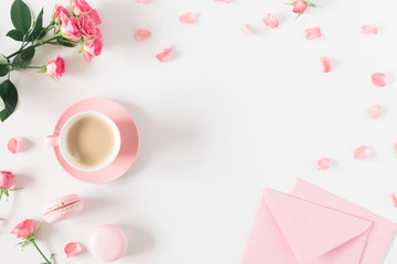 Flowers composition romantic. Flowers roses and rose petals, macaroon, cup coffee on white background. Happy women's day. Valentine's Day. Flat lay, top view