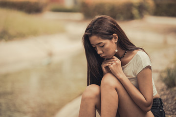 Beautiful thai woman very sad from unrequited love,She rethink and think over about love,vintage style,dark tone,broken heart,asian girl