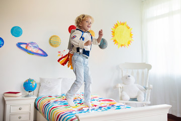 Kids play astronaut. Space and planet child game.