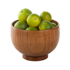 fresh limequat on white background in wooden plate