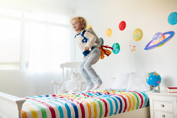 Kids play astronaut. Space and planet child game.