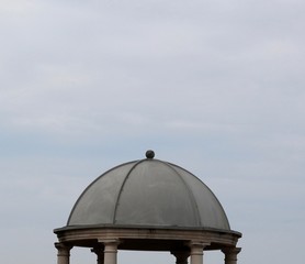 The top of the cement dome with the cloudy skies.