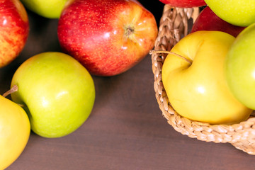 Multicolor apples, apples on bascket, wood background