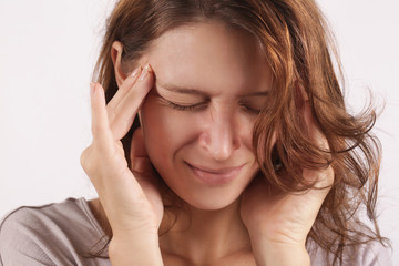 Studio shot of a young woman suffering from headache