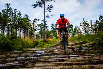 Cycling man riding on bike at sunset mountains forest landscape. Cycling MTB enduro flow trail track. Outdoor sport activity.