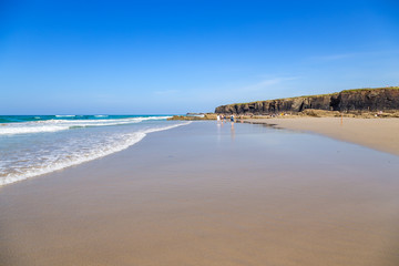 Ribadeo, Spain. Tourists on the picturesque Holy Water Beach (Praia de Augas Santas)