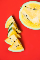 Fototapeta na wymiar cut off triangular slices of ripe yellow watermelon on white background
