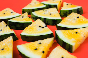 cut off triangular slices of ripe yellow watermelon on white background