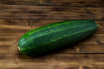 Green squash on dark wooden boards background