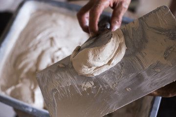 finished solution of the final putty in a plastic container, repair work