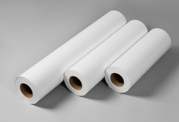 Fototapeta premium Blank white paper rolls isolated on gray background. Mockup paper for magazines, catalogs or newspapers isolated on gray backdrop, Printing house theme or wrapping paper for presents