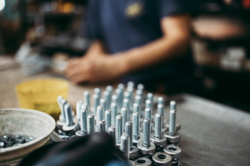 Close up shot of manual worker hands. Factory for industrial production of electric housings and surge arresters.