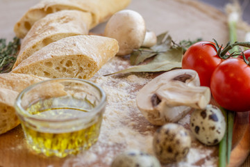 bread composition with herbs and vegetables on a baker's table