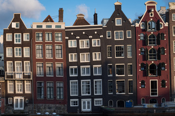 Fototapeta premium Amsterdam, Netherlands - August 2019: iconic crooked former warehouses now apartmetns in Amsterdam