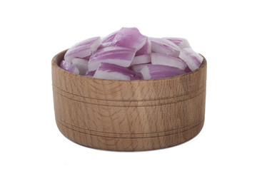 heap of slices fresh red onion in wooden plate isolated onwhite backgound