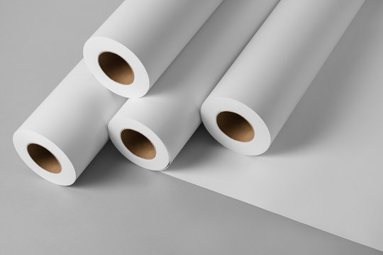 Blank white paper rolls isolated on gray background. Mockup paper for magazines, catalogs or newspapers isolated on gray backdrop, Printing house theme or wrapping paper for presents