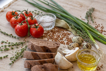 bread composition with herbs and vegetables on a baker's table
