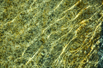  Natural granite under water. Waves create a unique pattern.
