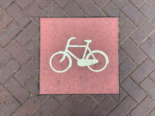 Bicycle lane sign on a paved road