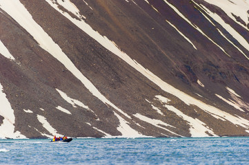 HORNSUND, SVALBARD, NORWAY – JULY 26, 2010:  Tourists in ocean rafts, Hornsund, Norway