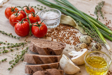 bread composition with herbs and vegetables on a baker's table