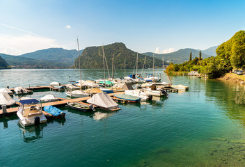 Fototapeta na wymiar Pier with boats on Lake Lugano in Morcote, Switzerland