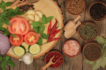 vegetables and spices on wooden background. top view
