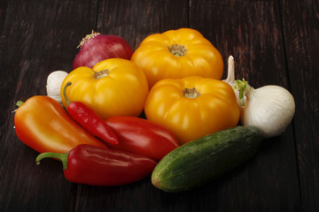 heap of different vegetables on wooden background