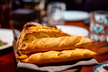 Basket with different bread on the table in the restaurant
