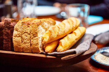 Basket with different bread on the table in the restaurant