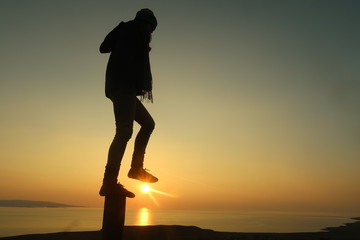 Girl silhouette at Sunset on the famous Isle of Skye 