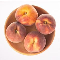 heap fresh peach in wooden plate  isolated on white background