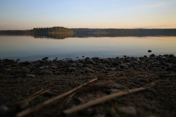 Sunset lake landscape with a boat