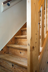 Fototapeta na wymiar Clean and new wooden staircase in modern home interior close-up
