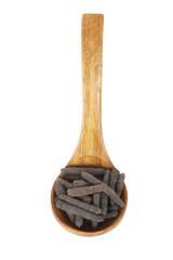 heap of pippali (long pepper) in wooden spoon isolated on white background