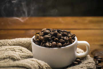 Cup with coffee grains on wooden table