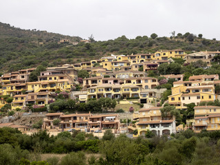 Fototapeta na wymiar Beautiful holiday resorts on a slope above the sea of Sardinia