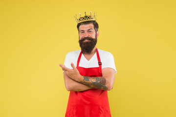 King of kitchen. Cook with beard and mustache yellow background. Royal recipe. Man mature cook wear cooking apron and golden crown. Ideas and tips. Chief cook and professional culinary. Cook food