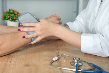 Obraz na płótnie Canvas Therapist measures a blood pressure to her patient.