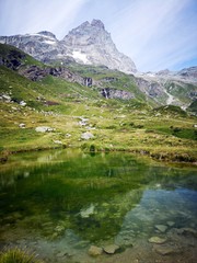 Fototapeta na wymiar Alpine lake with Monte Cervino - Matterhorn in the background - Italian Alps in Breuil-Cervinia