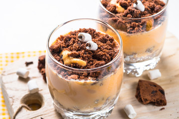 Halloween sweet dessert from cream pumpkin and chocolate.