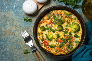 Frittata with fresh vegetables in the skillet.