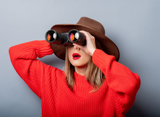 woman in red sweater and hat with binocular