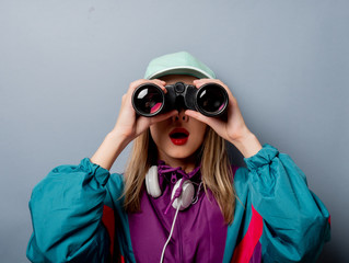 woman in 90s clothes style with binoculars