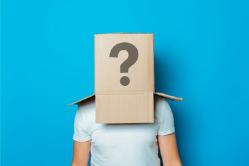 Young man in a white T-shirt with a cardboard box on his head on