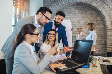 Group of business people working in office and discussing new ideas