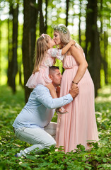 Pregnant woman and family outdoor